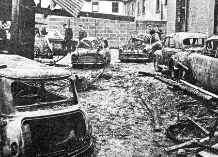 The devastating scene at the garage of local car dealer John Hamilton after an overnight fire ravaged his fleet of motors in 1966.