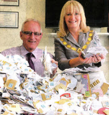 David Parkinson of Lisburn Hearing Centre and Debbie Roulston, current President of the Lagan Valley Rotary Club show off the amassed collection.