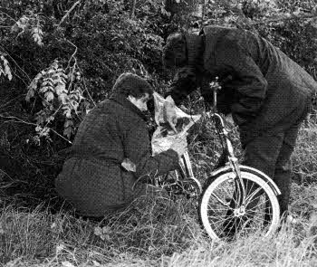Detectives examine Jennifer Cardy's discarded bike at Ballinderry in August 1981 - the body of the nine-year-old (above right) was found six days later in a roadside lay-by.
