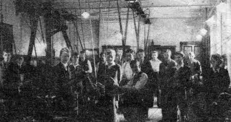 Metalwork class 1938. Included in the photo is sixteen year old student Joe Kennedy (fourth from right). After Joe's appointment as Maintenance Technician following the war, one of his flrst jobs was motorising the workshop machines and doing away the old overhead line shaft which can be seen in the background .