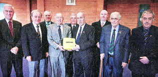 Alderman Jim Dillon, Chairman of the Pantridge Trust presents a defibrillator to Maurice Leathem, President of the Royal British Legion (Lisburn Branch). Also present are Adrian Donaldson, Director of Corporate Services, Lisburn City Council and members of the Royal British Legion Committee.