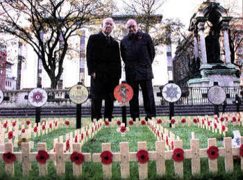 Ivan Davis 0BE and Colin Preen from Lisburn paying tribute at the Field of Remembrance at Belfast City Hall this week. Mr Davis said it was a great honour and privilege to dedicate a Remembrance tribute and to visit the rows of poppies.