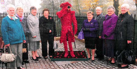 Members of the Women's Section of the Lisburn Branch of the Royal British Legion at the 'Poppy Man' at Lisburn War Memorial following the launch of the poppy appeal. L to R: Ethel Bradford, lsabel Parker, Edna Nimmons, Yvette Williamson, Roberta Irwin (Secretary), Margaret Smylie, Joan Lavery and Anne Hood.