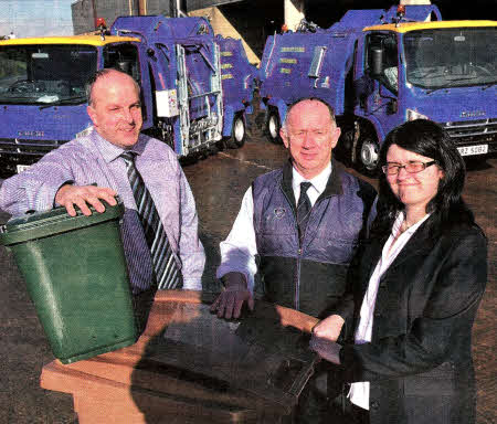 With the new refuse collection vehicles and recycling containers are: (l-r) Councillor James Tinsley, Chairman of the Council's Environmental Services Committee; Mr Tommy Wilkinson, Cleansing Supervisor for Lisburn City Council and Mrs Noeleen O'Malley, Acting Assistant Director of Environmental Services (Technical).