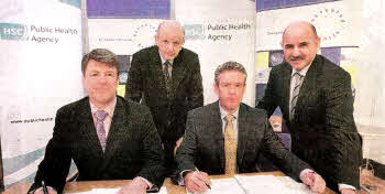 Hugh McCaughey, South Eastern HSC Trust Chief Executive (pictured far left) with Jon Lowe, Managing Director of Tunstall Healthcare (seated right), the Minister for Health, Michael McGimpsey and Dr. Eddie Rooney, Public Health Agency, at the contract signing with the Trust and Tunstall, bringing remote monitoring technology to patients in their own homes.
