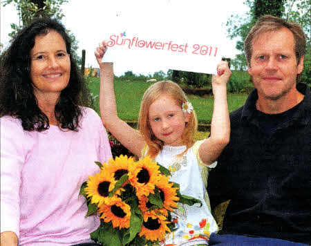 Sunflowerfest event directors Vanessa and Michael Magowan join seven year old Juliet Shaw down at Tubby's Farm for the launch of Sunflowerfest 2011.