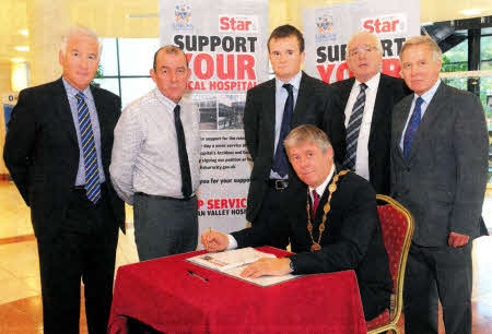 Launching the petition to show support for a 24 hour service at Lagan Valley Hospital Accident and Emergency Department are the Council's cross-party delegation. Pictured are p-r) Mr Adrian Donaldson, Director of Corporate Services; Councillor Arder Carson, SF; Councillor Stephen Martin, Chairman of the Corporate Services Committee, Alliance; Alderman Allan Ewart, DUP and Councillor Brian Bloomfield, UUP. Seated is the Mayor, Councillor Brian Heading, SDLP. 
