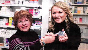 Demonstrating the test is Ellenor Calvert from Lisburn whose test in January 2010 detected she had diabetes along with Gordons Pharmacist Aine McManus.