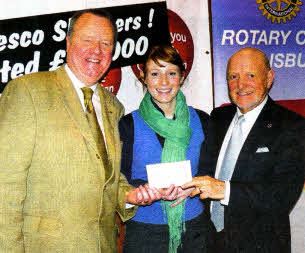 Sarah Quinlan of the Children's Heartbeat Trust receives a cheque from John Mcllroy and John Gilliland.