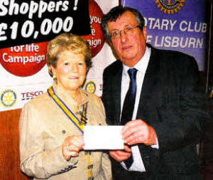Stephen Thompson of the Motor Neurone Society receives a cheque from Shirley McMinn, President of Lisburn Inner Wheel.