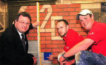 Lisburn bricklaying trainee Philip Green, who will be competing in the Worldskills final next week, with Wall and floor tiling trainee Ian McMahon and Employment and Learning Minister Dr. Stephen Farry at the Worldskills training camp held at North West Regional College in Limavady recently.