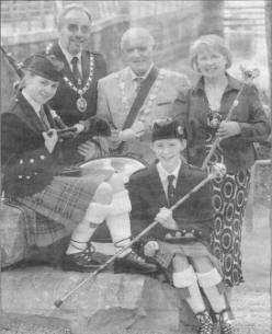 Beating the drum to launch the 2004 European Pipe Band Championships are The Mayor and Mayoress of Lisburn, Councillor Cecil and Ellenor Calvert, accompanied by Mr George Usher, President of Pipe Band Association and local rivals Emma Chambers (14) and Elizabeth Sloan (14), who will both compete in the Championships this Saturday 31st July in Lisburn LeisurePlex. Over 130 bands of pipers, drummers and drum majors from across Europe are expected to entertain a crowd of 10,000 visitors. Photo John Harrison.