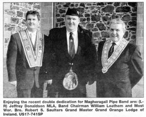 Enjoying the recent double dedication for Magheragall Pipe Band are: (LR) Jeffrey Donaldson MLA, Band Chairman William Leathem and Most Wor. Bro. Robert S. Saulters Grand Master Grand Orange Lodge of Ireland. US17-741SP