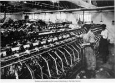 Workers surrounded by the roar of machinery in the linen factory.