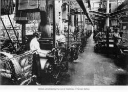 Workers surrounded by the roar of machinery in the linen factory
