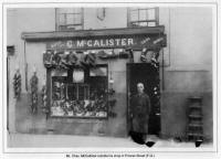 Mr. Chas. McCallister outside his shop in Princes Street (F.G.)