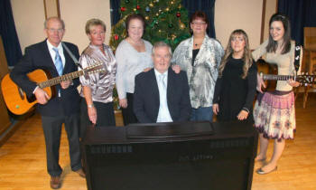 The Derryvolgie Singers. L to R: Jim Hamilton, Liz Spence, Thelma Campbell, Karen McIvor, Emma-Louise Spence, Lindsay Hamilton and Graham Murphy (seated at keyboard).