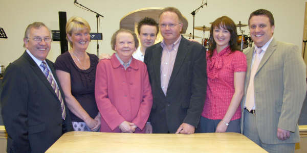Mrs Lois Cregan, a long serving member of the Hillsborough fellowship, who performed the re-opening of the refurbished Church Worship Centre in February 2009 is pictured with her son Irwin and grandson Andrew. Also included are Pastor James Ritchie and his wife Vanessa (left) and Associate Pastor Alistair Ritchie and his wife Alison (right). 