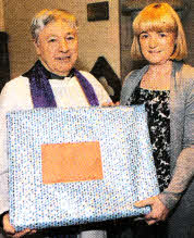 Mrs Margaret Hegarty pictured presenting a gift to the Rev Raymond Devenney on behalf of the Drumbeg Resident's Association.