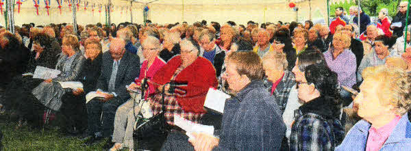 Members of five local churches pictured enjoying a programme of rousing praise and celebratory music provided by Baillies Mills Accordion Band.
