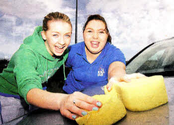 Emily Graham and Dawn Hawthorne taking part in a charity car-wash at Annahilt Orange Hall to help raise funds for Bible camps for under-privileged children in Ukraine. US1212.510cd
