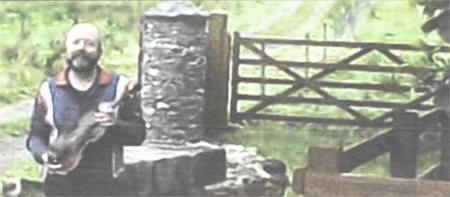 Michael Costello with a Gordon Violin, at the entrance to Hugh Gordon's old homestead at Lower Ballymacward, Stoneyford