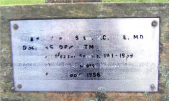 A plaque at the base of a tree, at Warren park, Lisburn. It bears the name of Brigadier John A. Sinton, a recipient of the Victoria Cross. Some other plaques dedicated to former citizens have gone missing.