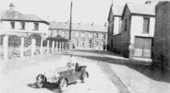 A reader kindly provided this photograph of Davy Jones. Here he appears in a car that pre-dates his Cheetah-Cub. Houses in Antrim Street can be seen to the rear of the photograph and to the right of the picture is Antrim Lane, also known as 'Buggy Row', where Davy resided.
	