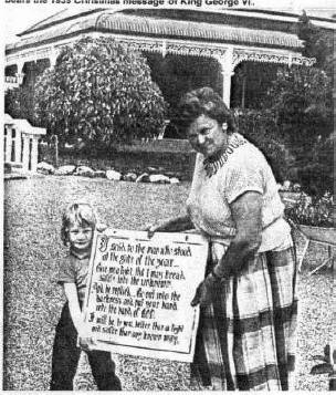 Norma Higginson and her granddaughter, Shivawn, with one of the signs Mrs Higgins has featured in the gardens of 'Woodville'. The sign bears the 1939 Christmas message of King George VI.