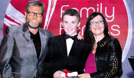 12-year-old Adam Kerr receives his award from Dr. Neil Fox and Arlene Phillips in 2011