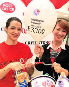Creightons of Finaghy staff Rosetta Maxwell and Ruth Little present Northern Ireland Hospice with £3700. The funds were raised through Creightons staff taking part in the charities annual Hospice Walk.