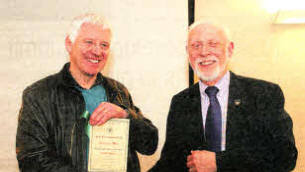 Dumnurry's Martin Lamb left from BPIC camera club receiving his award from NIPA president Danny McCaughan.