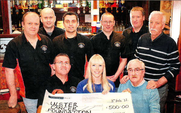 Maeve Fox (centre), from the Ulster Cancer Foundation, receives a cheque for £500 from members of Hillsborough 'A' darts team who raised the money during a New Year's Day darts competition. US0612-520cd