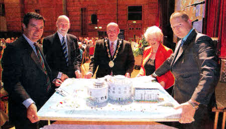The magnificent cake, which replicated the Lagan Valley Island building, created by Sgt Johnny McCusker on the occasion of the celebration of 10 years of City Status (l-r) Lt Col. Nick Ilic; Mr Norman Davidson, Chief Executive Lisburn City Council; the Mayor, Alderman William Leathern; Lord Lieutenant, Mrs. Joan Christie and Sgt Johnny McCusker.