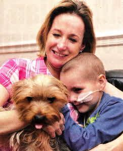 Patrick Campbell with his mother Mairead and his pet dog Tiddles. US1512-402PM Pic by Paul Murphy