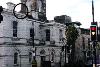 Youths running along the roof of the Lisburn Museum (circled).