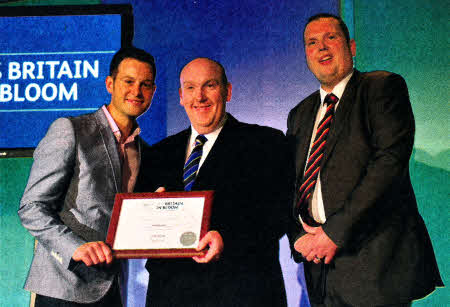 Collecting a Silver-gilt award at Hillsborough's first-time showing at the Britain in Bloom Awards, Europe's largest horticultural awards, from Matt Baker, BBC Presenter, is the Mayor of Lisburn City Council, Alderman William Leathem and Cllr. Andrew Ewing, Chairman of the Council's Environmental Services Committee.