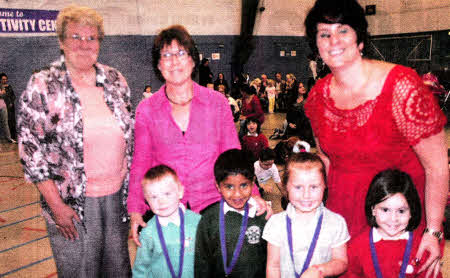 Geraldine Tigchelaar (Integrated Education Fund former Chair) with Lois Wilson of Pond Park Nursery and Clare McAllister of St Aloysius Nursery with children from both pre-schools as they celebrate the success of their cross-community activities on an IEF PACT (Promoting a Culture of Trust) scheme.