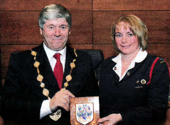 Lisburn Mayor, Councillor Brian Heading presenting a plaque to Alison Stevenson (Captain) to mark the 50th anniversary of the formation of St Paul's Girls' Brigade Company.