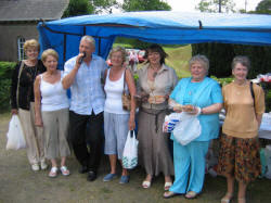 Crooner Brian Thompson entertains some ladies at the cake stall during the Garden Party at Kilwarlin Moravian Church on Saturday 10th June.  L to R:  Margaret Gibson, Alice Heatley, Brian Thompson, Hazel Scott, Valerie Walker, Hazel Law (Church Treasurer) and Violet Best.
