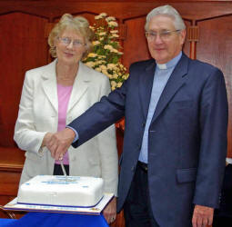 The Rev Robert Lockhart and his wife Betty pictured cutting a cake celebrating the 30th Anniversary of the work and witness at Elmwood Presbyterian Church.