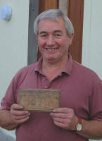Ronnie Douglas is pictured holding a piece of wood found in the cavity wall of the building with a hand written note showing the start and completion date and year that the hall was built.