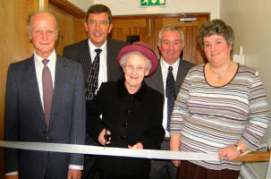 Mrs Babs Fox is pictured cutting the tape to mark the official opening of the new Magheraknock Mission Hall last Saturday afternoon (11th November). Included is L to R: Sam Sommerville, Trevor Matthews - Faith Mission, Babs Fox, Ronnie Douglas and Ethne Douglas.
