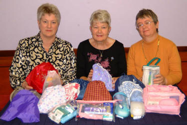 Office bearers of the Derriaghy branch of the Mothers� Union branch are pictured with filled toilet bags for use by emergency patients at the Lagan Valley Hospital. L to R: Pat Allen (Secretary), Trudy Hull (Chairperson) and Margaret Hanthorne (Treasurer).