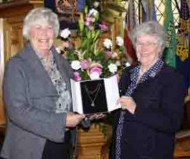 Mrs Elizabeth Walker - Vice President of Ballycairn PWA is pictured presenting a gift to Mrs Maje Sinclair in recognition of over 32 years service as President of Ballycairn PWA. The photo was taken at the final service in the active ministry of Maje's husband, the Rev Victor Sinclair in Ballycairn Presbyterian Church last Sunday morning (1st April)