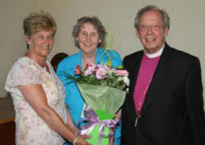 Carol Field presents a bouquet of flowers to Mrs Noreen Poyntz and the Rt Rev Dr Samuel Poyntz (former Bishop of Connor).