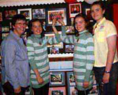 Past pupils - twins Emma and Ami Thompson point themselves out in a 2004-2005 school photo to mum Sandra (left) and sister Alix (right).
