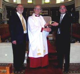 The Rev Canon William Bell is pictured after receiving a gift to mark the 40th Anniversary of his Ordination from Geoffrey Simpson, Rector's Churchwarden (right) and Jack Price, People's Churchwarden (left) following Morning Prayer at Eglantine Parish Church on Sunday 24th June.