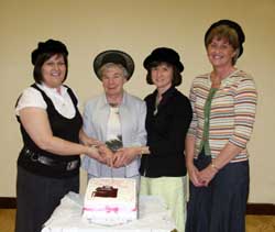 Miss Marjorie Boreland MBE (second from left) cuts a cake marking her retirement as organist of Hillsborough Free Presbyterian Church (1967-2007). Assisting her is L to R: Patricia Hamilton, Elizabeth Gardner and Ida McCready. 