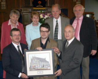 Jason Kelly presents his painting of First Dromore Presbyterian Church to the Minister, the Rev Keith Duddy and Cecil Gamble - Clerk of Session